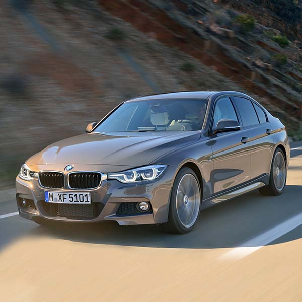 BMW driving on road